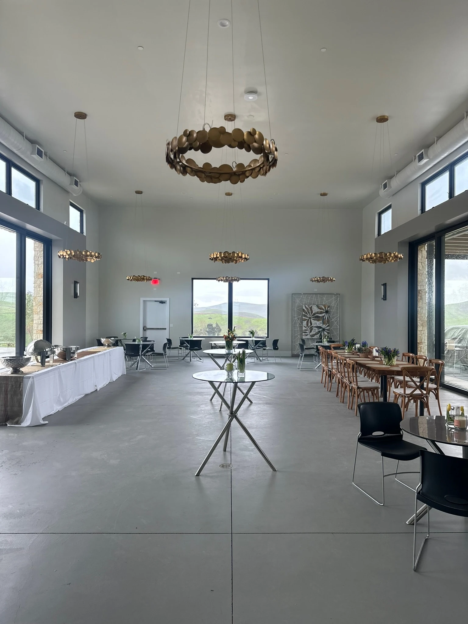 Brass chandeliers and vineyard views in the estate production room